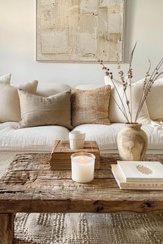 a living room with a couch, coffee table and vase on it's side