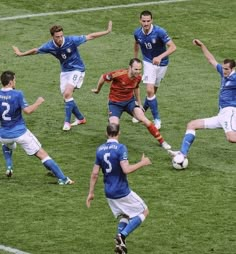 a group of men on a field playing soccer