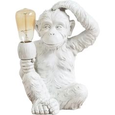 a statue of a monkey holding a light bulb