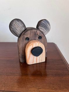 a wooden bear head sitting on top of a table