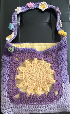 a crocheted purse sitting on top of a black chair