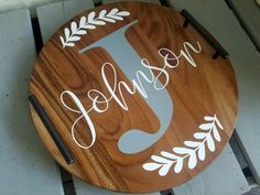 a wooden sign with the word john and an initial on it, sitting on top of a pallet