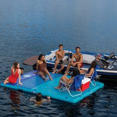 a group of people sitting on top of a raft in the water