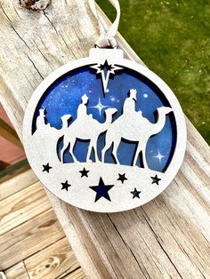 a christmas ornament with three wise men riding on camels and the star of david