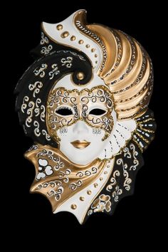 a black and white mask with gold accents