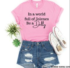 In a world full of Jolenes, be a Dolly shirt. Pink Gildan Soft Style. Dolly Parton Tee Shirt, By Dolly Shes One, In A World Full Of Jolenes Be A Dolly, Boutique Shirt Ideas, Dolly Shirt Ideas, Dolly Parton Tshirts, Dolly Parton Shirt Ideas, Dolly Parton Party Ideas, Jolene Shirts