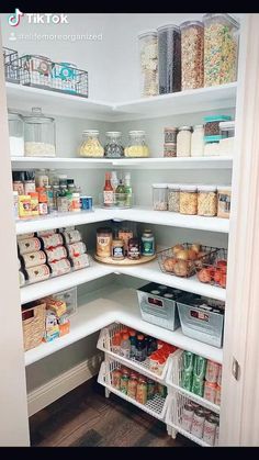 an organized pantry with white shelving and lots of food