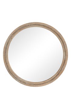 a round mirror with beaded trim around the edges and an oval frame, on a white background