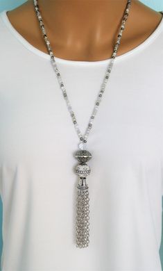 "Four different styles of silver beaded tassel necklaces to choose from, designed and handmade by Ralston Originals. I made all the tassels with silver chains, and covered each in a beautiful antique silver metal bead cap. The first beaded necklace (Pictures 1-3), is made with a very unique and beautiful large silver bead, with many tiny crystal inlaid accents. The necklace is also made with a large antique silver crystal roundel, and a large clear crystal bead. The beaded chain on the necklace Luxury Single Strand Beaded Necklaces As Gift, Luxury Long Single Strand Beaded Necklace, Cheap Long Beaded Necklace With Round Beads, Luxury Traditional Sterling Silver Beaded Necklace, Handmade Silver Long Tassel Necklace, Damas Jewellery, Faux Collar, Collar Necklaces, Beaded Jewelry Necklaces