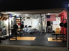 an indoor gym is lit up at night with american flag on the wall behind it