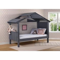 a child's bed with a little house on it