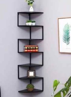 a corner shelf with books and plants on it next to a potted plant in the corner