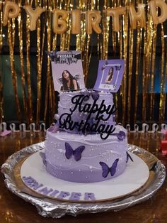 a purple birthday cake with an image of a woman on top and butterflies around it