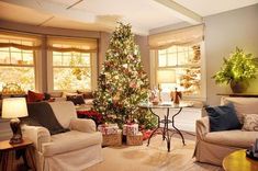 a living room filled with furniture and a christmas tree