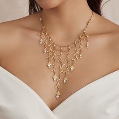 Elevate your neckline with our exquisite Romilly Necklace, crafted with a radiant 24K gold-plated metal base and adorned with shimmering genuine clear crystals. Its dainty and intricate vine inspired design gracefully cascades over your neck, adding a touch of enchantment to any ensemble. This statement necklace features a simple lobster claw closure for easy wear. All jewelry is made to order in our New York City design studio. Please allow 7-14 business days for production from the order date. Wedding Necklace Sweetheart Neckline, Gold Elegant Jewelry, Gold Formal Jewelry, Gold Necklace Fancy, Vine Necklace, Trendy Silver Jewelry, Gold Statement Jewelry, Bridal Statement Necklace, Prom Goals