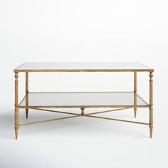 a golden coffee table with glass top