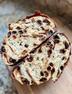 two pieces of bread sitting on top of a wooden cutting board