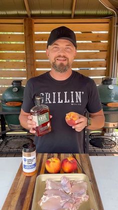 a man holding two apples and some meat