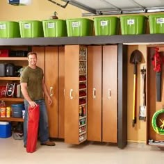 a man is standing in front of some lockers with green buckets on top