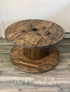 a round wooden table sitting on top of a hard wood floor