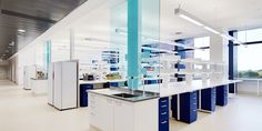 an empty laboratory with blue and white cabinets