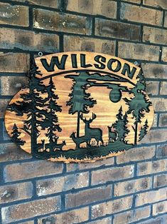 a wooden sign mounted to the side of a brick wall that says, wilson park