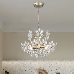 a chandelier hanging from the ceiling in a kitchen