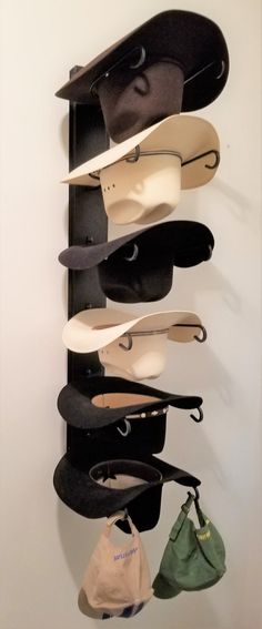 several pairs of shoes are hanging on a wall with hats and purses attached to it