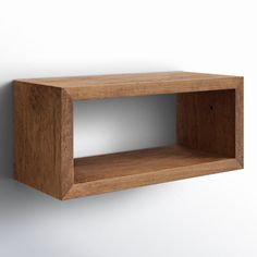 a wooden shelf mounted on the wall with one section missing from it's side