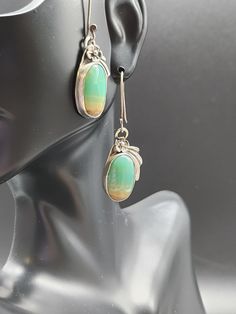 Beautiful Blue/green Opal Petrified wood and sterling silver Earrings. Beautifully handcrafted with genuine Indonesian blue/green opal petrified wood that has been gently bezel set in sterling silver.  These earrings are set on .997 pure silver Karen Hills tribe ear wires.   Native American handcrafted signed and stamped sterling. Please see my store for matching necklace, and other similar items handmade from the same stone. Measures: 1 3/4" L x almost 1/2" W Jewelry Type: Earrings Closure Type Handmade Gifts For Her, Green Opal, Petrified Wood, Wood Earrings, Matching Necklaces, Earrings Sterling Silver, Pure Silver, Sterling Silber, Beautiful Blue