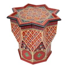 an intricately painted wooden box is shown in red and gold colors, with geometric designs on the sides