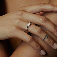 a woman's hand with a ring on her finger