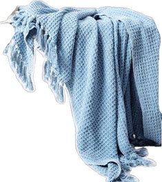 a blue crocheted blanket draped over a white background