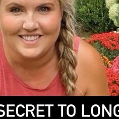 a woman with braids smiling in front of flowers and the words secret to long hair