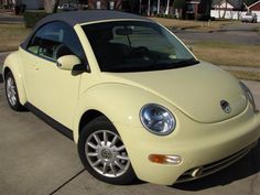 a yellow car is parked on the street