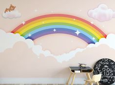 a child's room with a rainbow wall mural