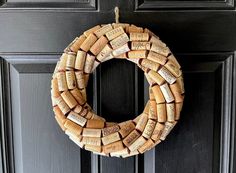 a wreath made out of wine corks hanging on a door