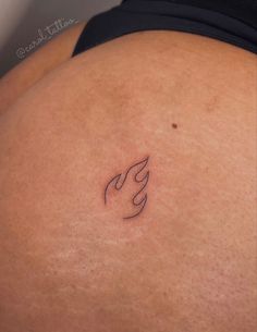 a woman's stomach with a small tattoo on it