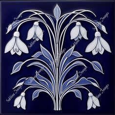 a blue tile with white flowers and leaves on it's side, against a dark background