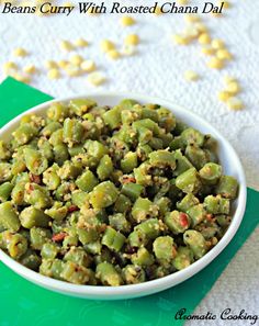 beans curry with roasted chana dali in a white bowl on a green napkin