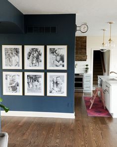 a living room with blue walls and pictures on the wall