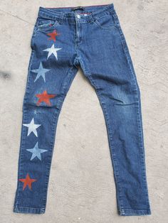 a pair of jeans with red, white and blue stars painted on the bottom of them