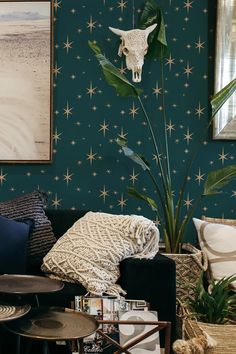 a living room filled with lots of furniture and walls covered in star patterned wallpaper