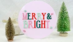 merry and bright sign surrounded by christmas trees on white background with presents in the corner