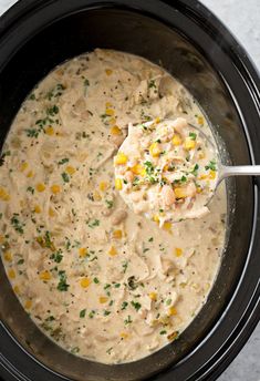 a crock pot filled with chicken and corn soup