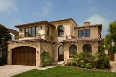 a large house with two car garages on the front and one story above it