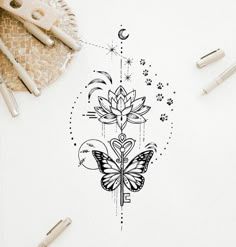 a drawing of a butterfly and flower on paper next to pens, scissors and pencils