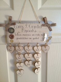 a sign hanging on the front door with hearts and buttons attached to it's sides