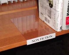 there is a book on the shelf next to it's plastic case and box