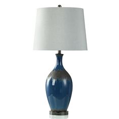 a blue table lamp with a white shade